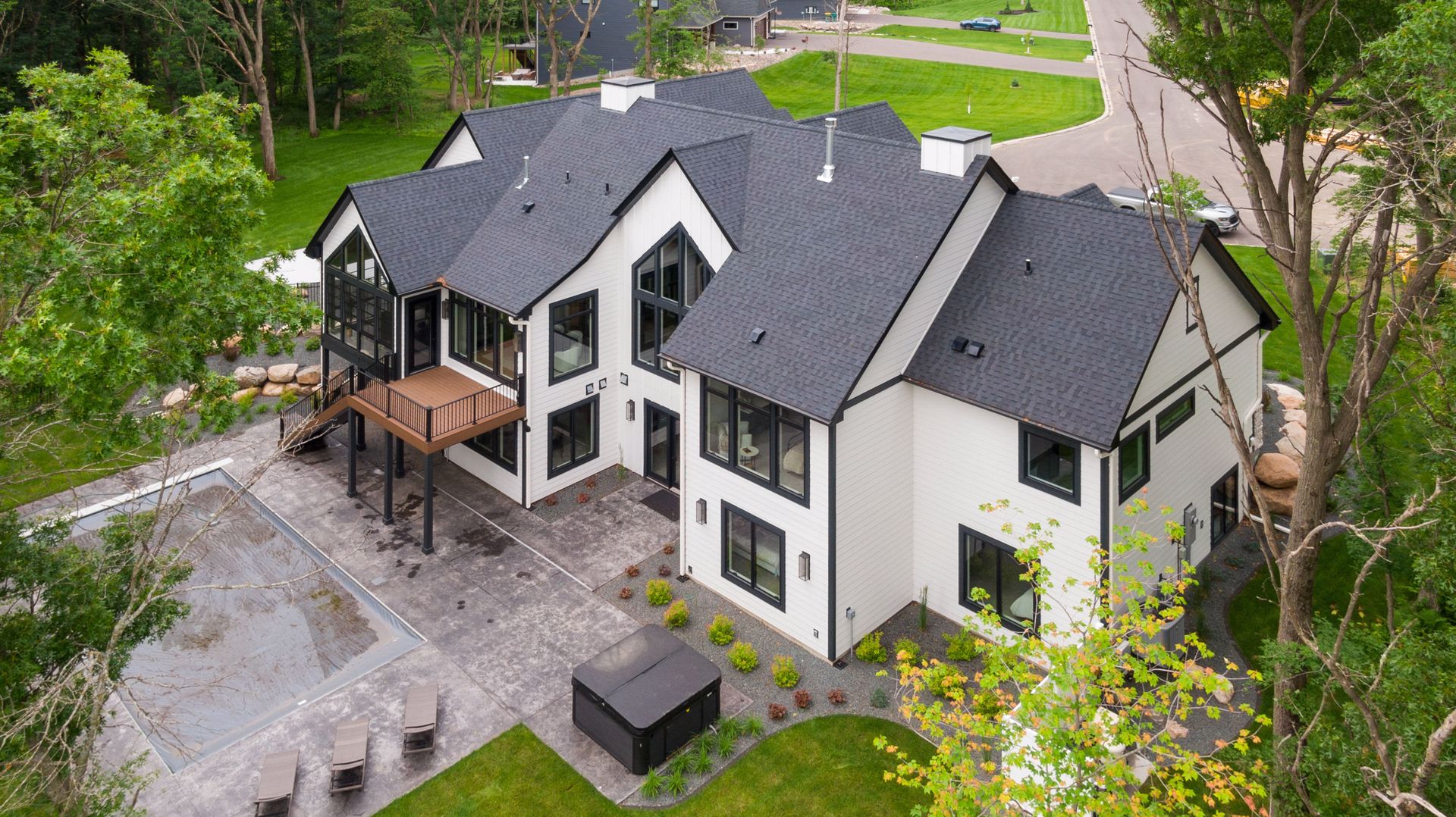 Aerial view of home rear exterior and pool
